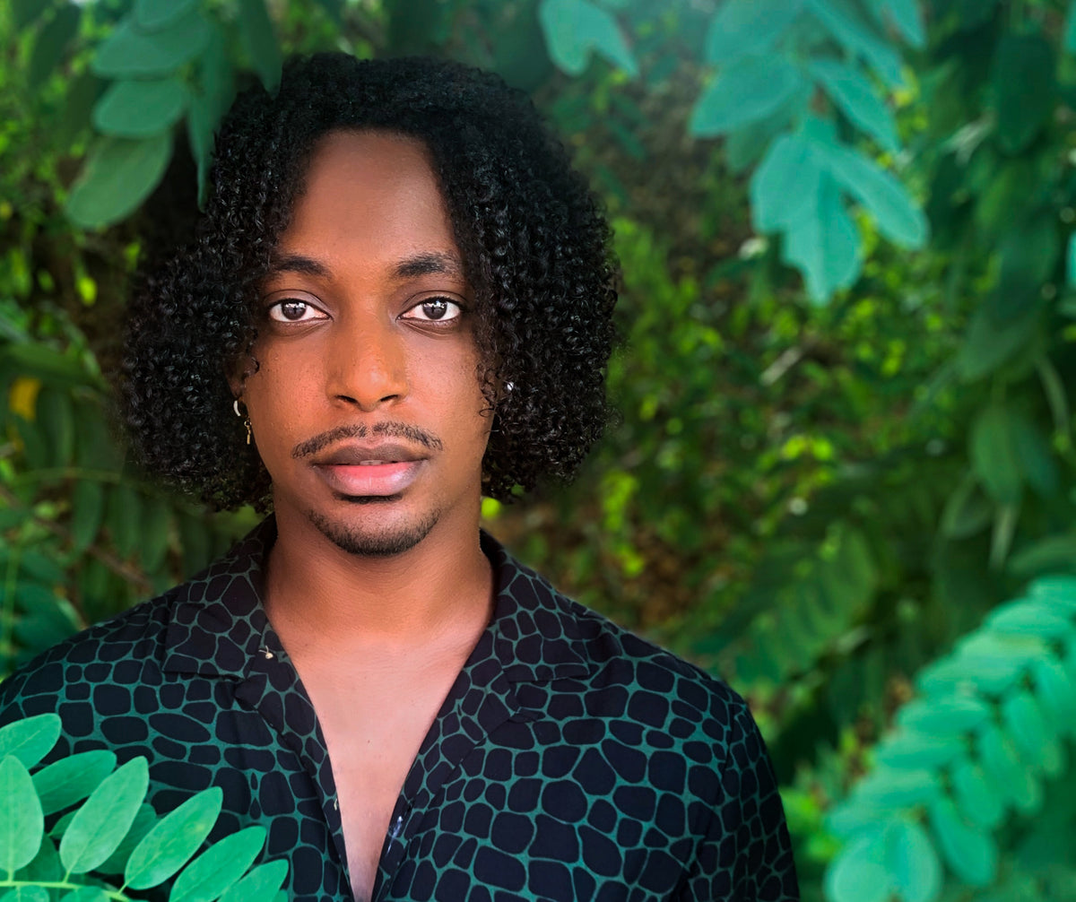 Winston, founder of Stonee Hair, wearing defined textured curls